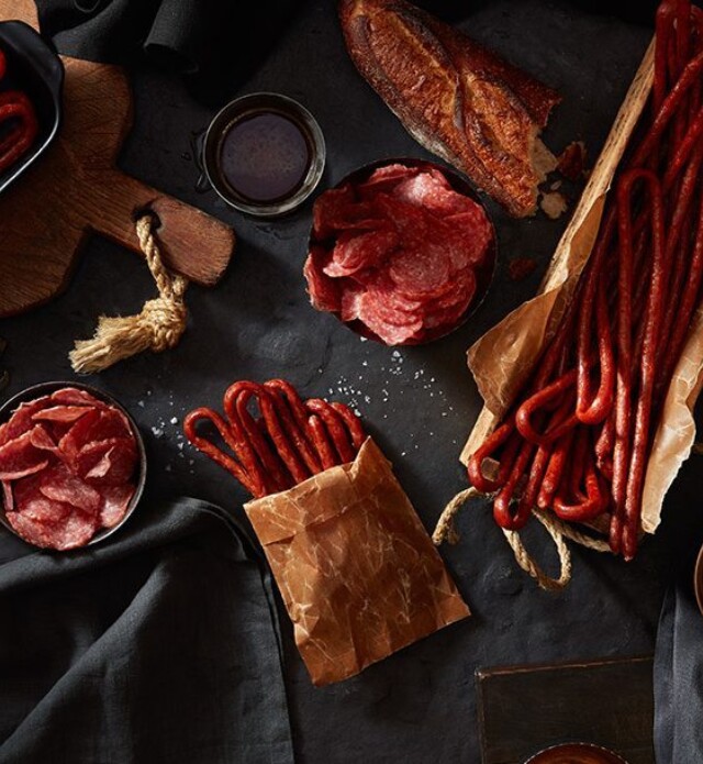 meat snacks in parchment paper on a black slate