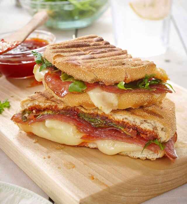 Salami and cheese grilled panini on a cutting board