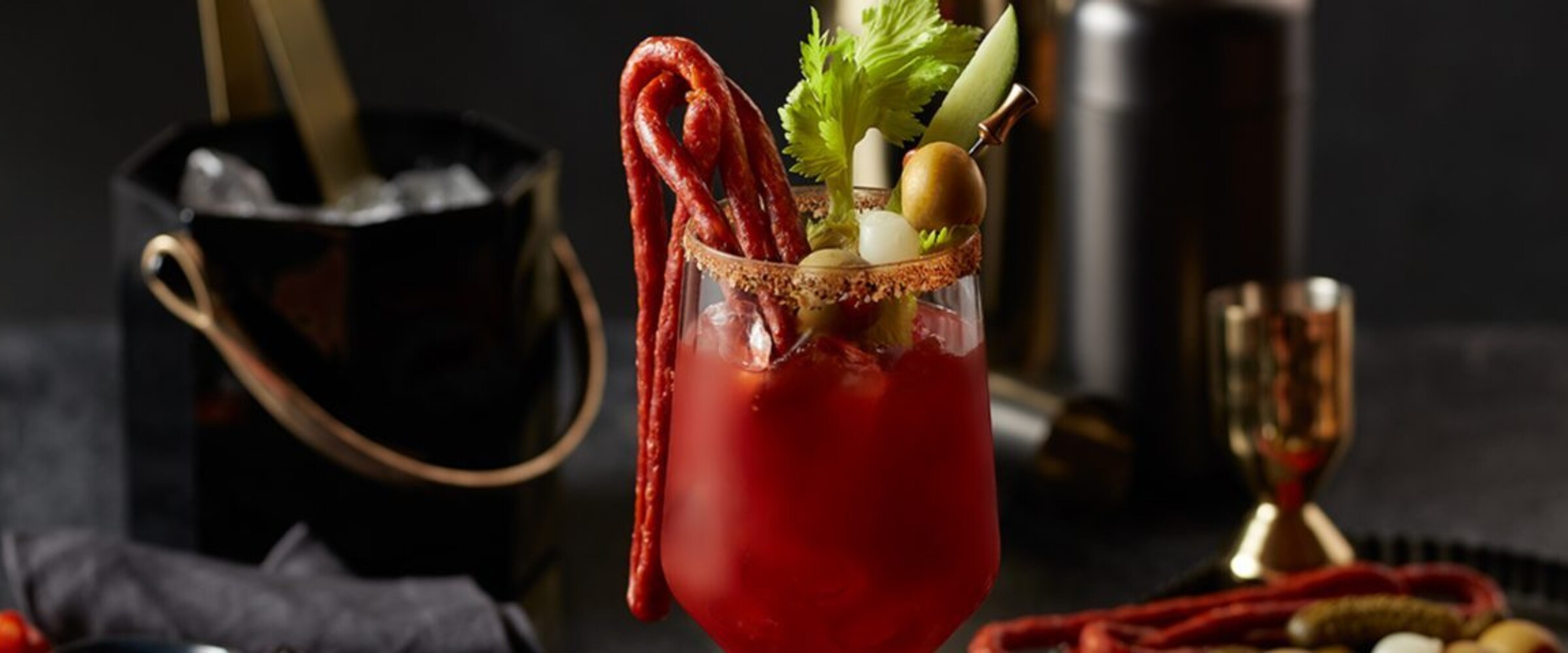 Bloody mary with salami whip, celery and olive garnishes