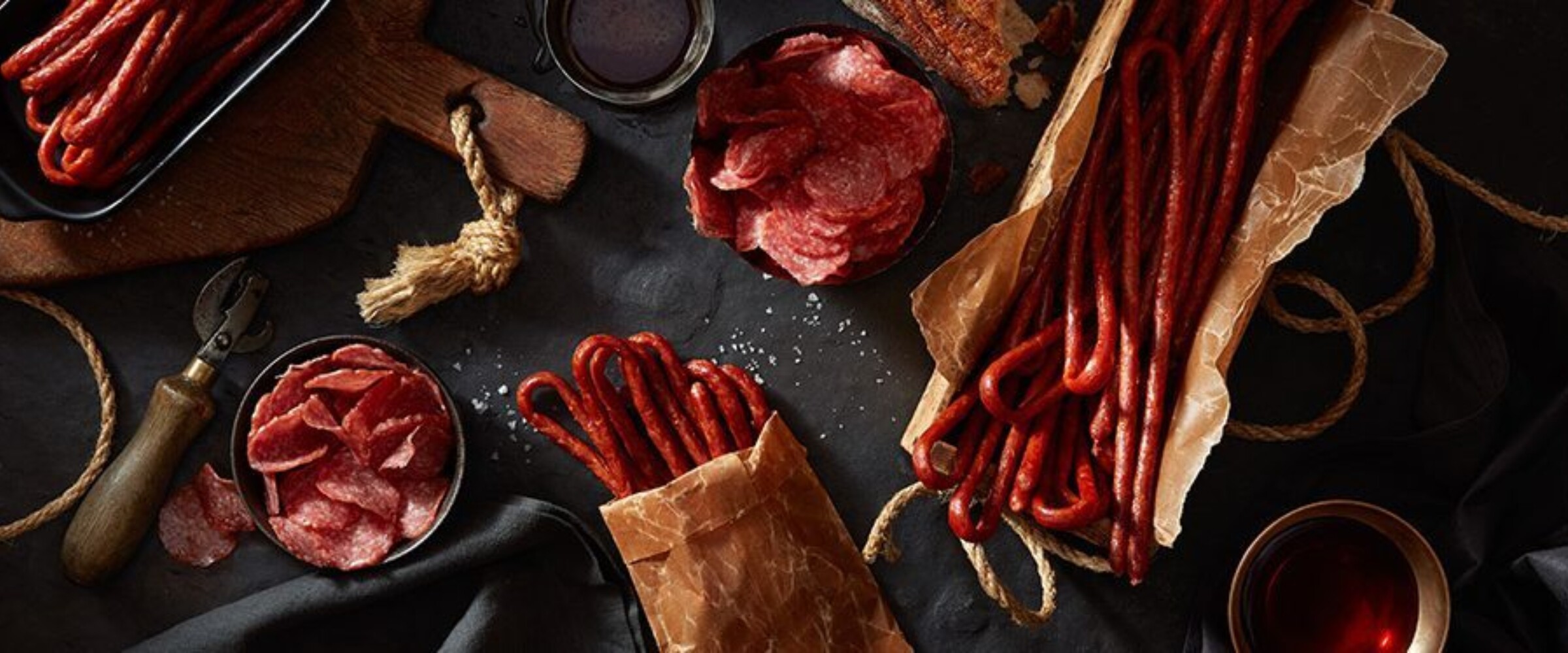meat snacks in parchment paper on a black slate