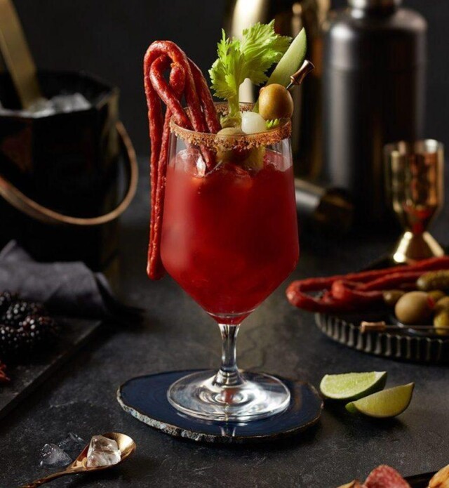 Bloody mary with salami whip, celery and olive garnishes