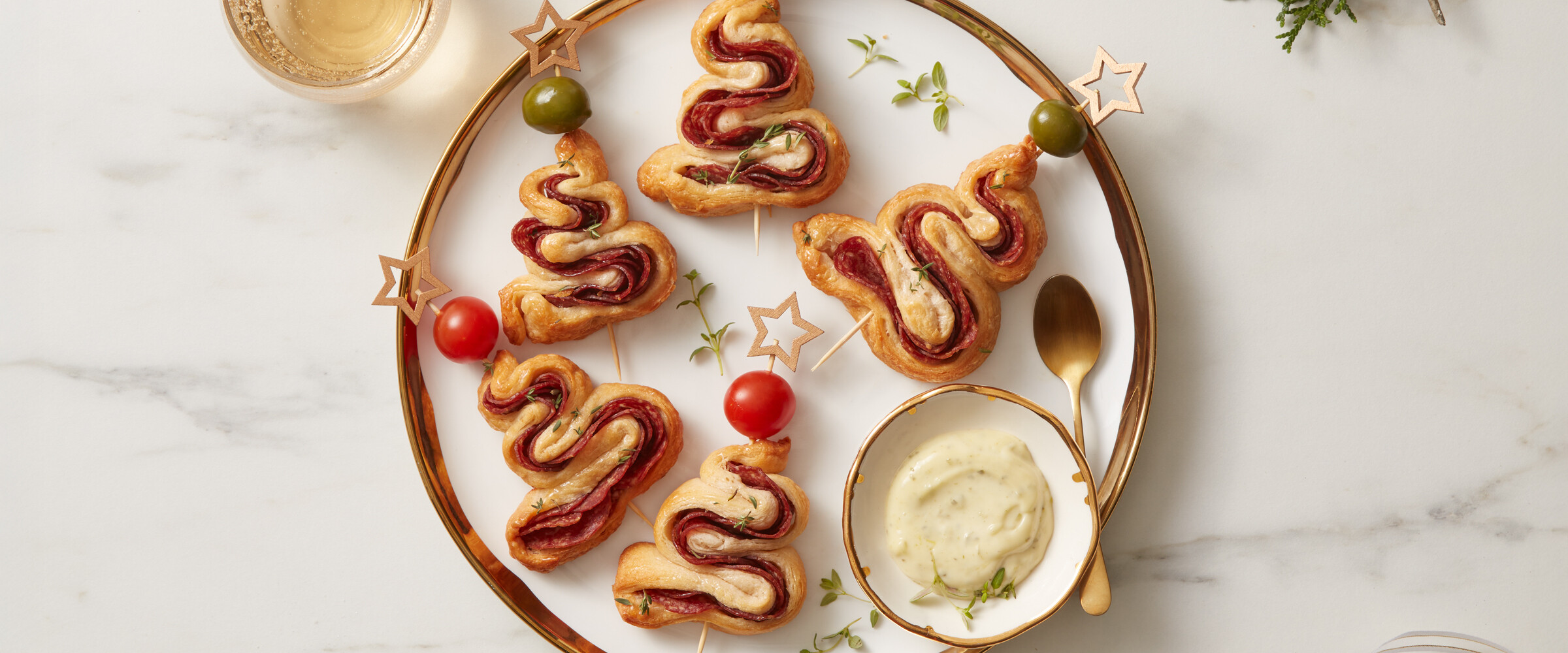Pastry and salami cooked in the shape of a tree on a serving plate