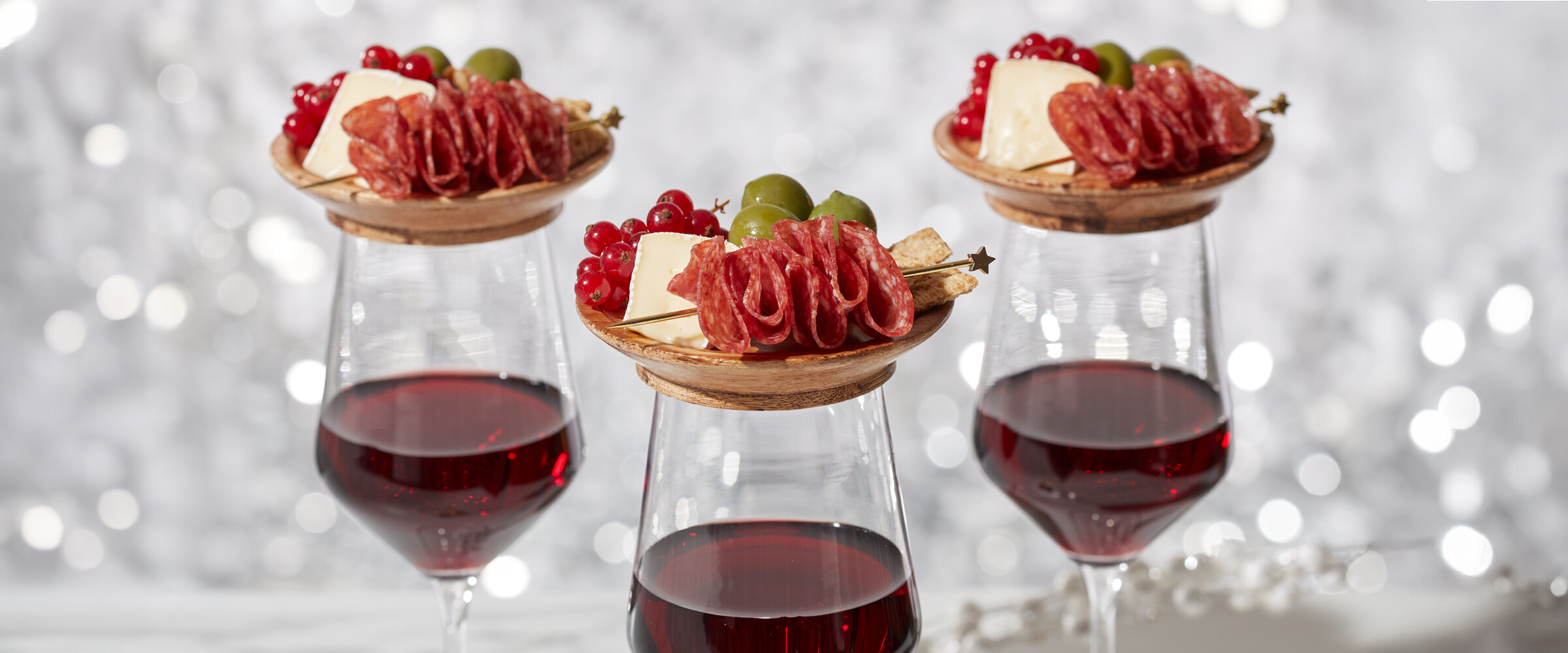Mini Charcuterie boards on top of wine glasses