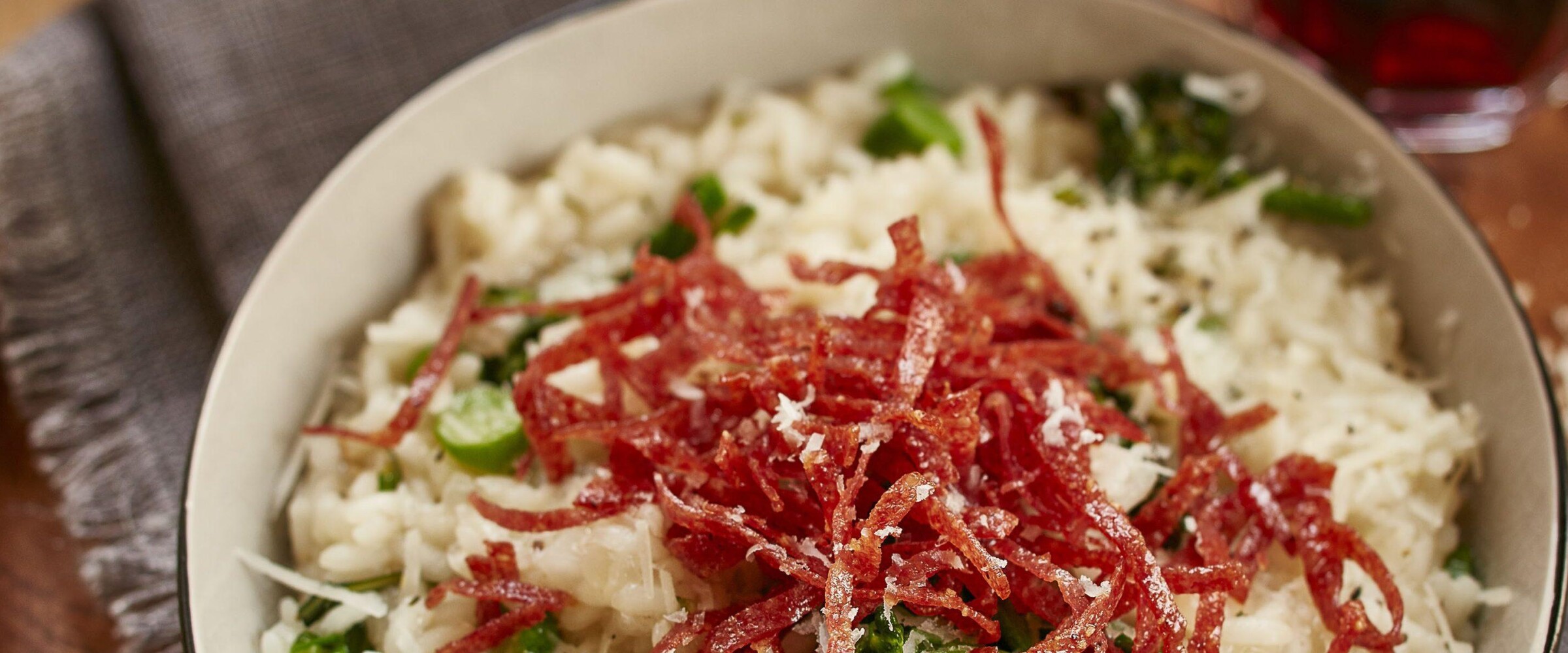 Risotto with salami in a white bowl