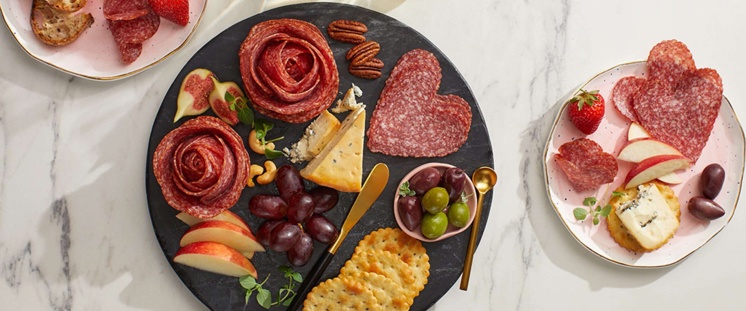 Heart & Flower shaped salami on a black board