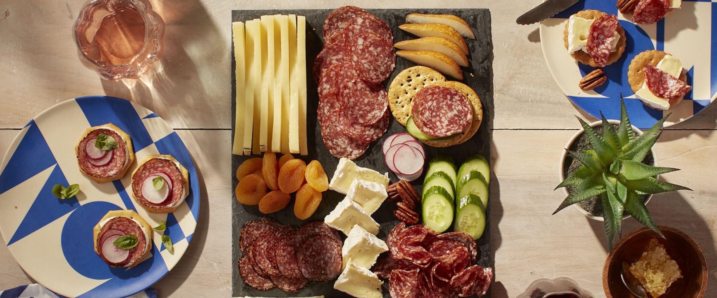 Patio charcuterie board with salami, crackers, cheese