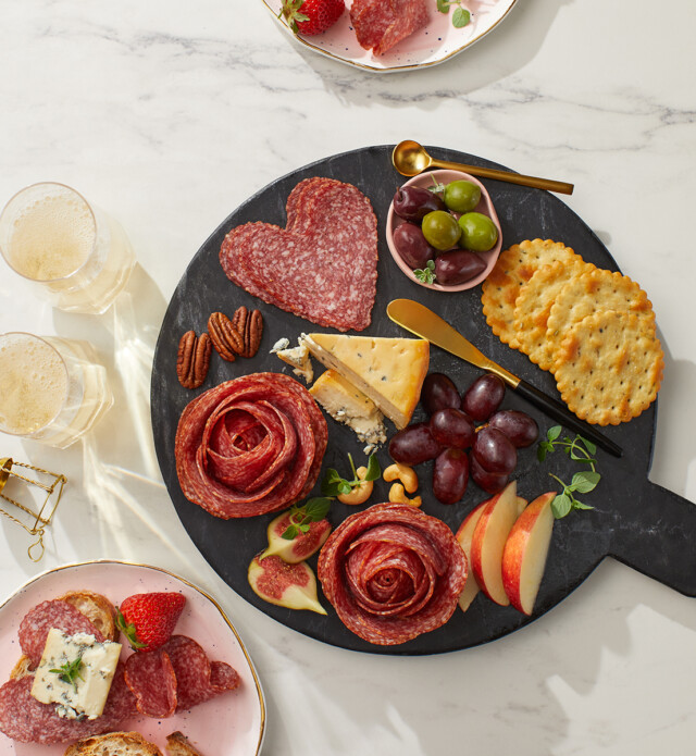 Heart & Flower shaped salami on a black board