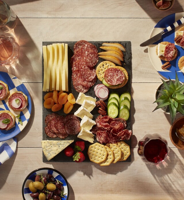 Patio charcuterie board with salami, crackers, cheese
